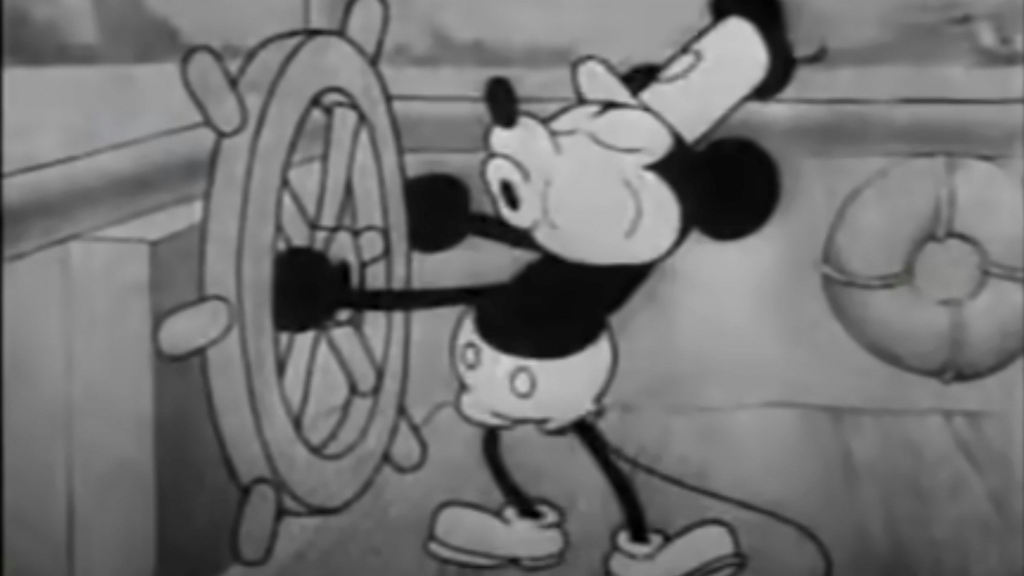 This still image from video provided by Disney shows the character Mickey Mouse in the 1928 animated short "Steamboat Willie." On Monday, Jan. 1, 2024, the iconic character from “Steamboat Willie” entered the public domain after the expiration of the 95-year copyright, and is already the focus of two horror films. (Disney via AP)