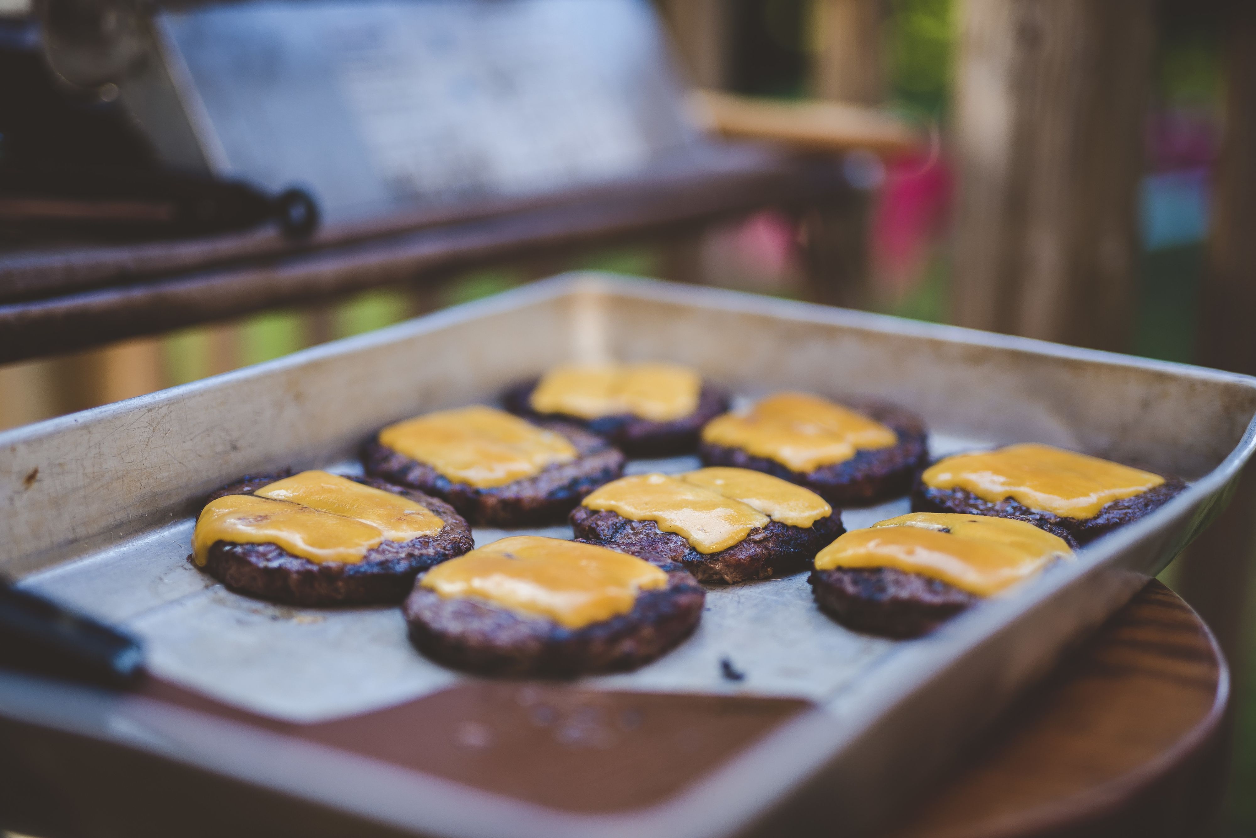 RECORD DATE NOT STATED A selective focus shot of hamburger meats with cheese on a tray *** einer selektive Fokus erschossen des Hamburgerin Fleischsorten mit K