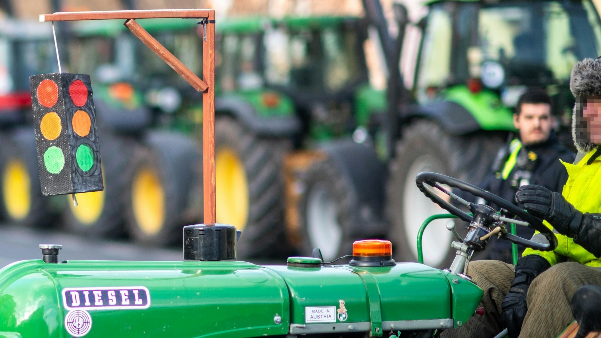 An einem Oldtimer-Traktor ist ein Galgen mit einer Ampel als Protest gegen die Politik der Ampelkoalition zu sehen.