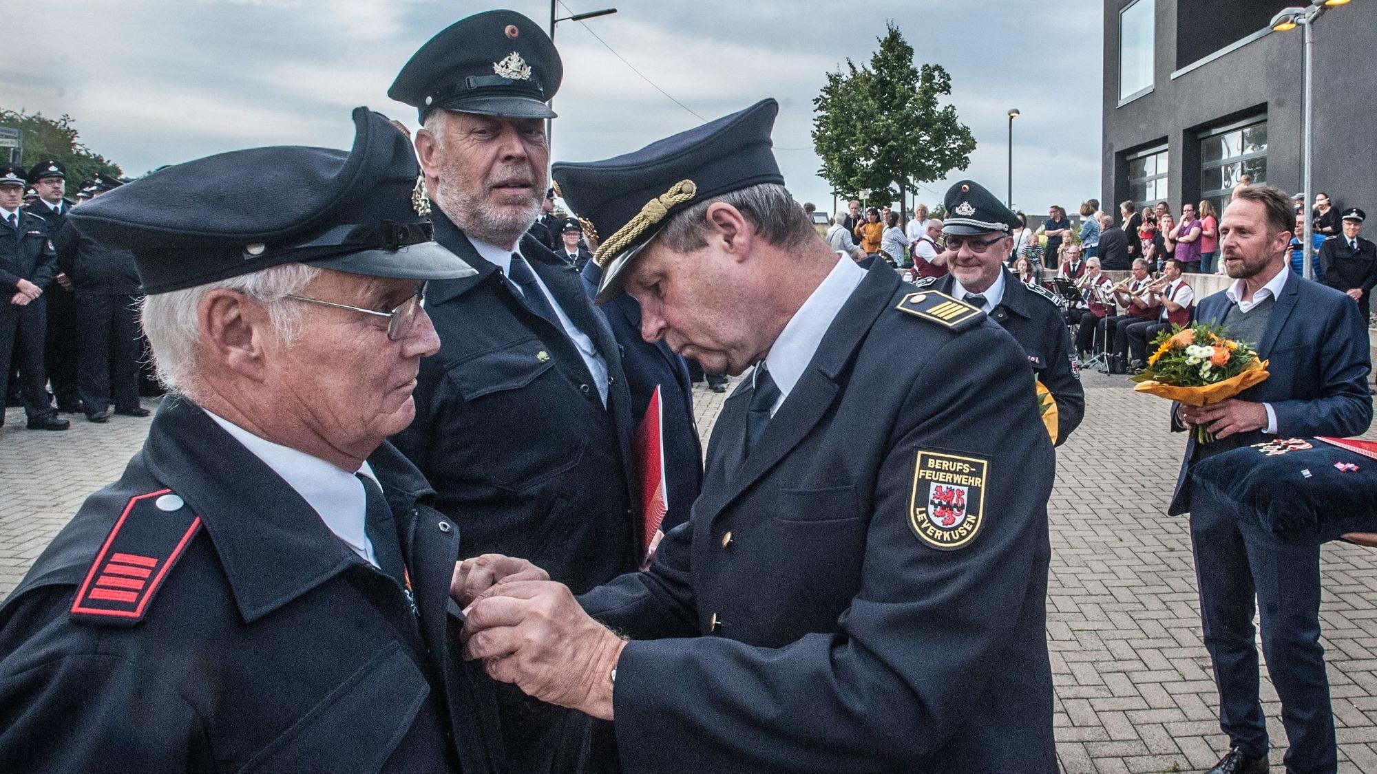 Ehrung Friedhelm Kamphausen (hinten und , durch Hermann Greven. Ehrungen Stadtfeuerwehrtag Feuerwache Steinbüchel, Foto: Ralf Krieger