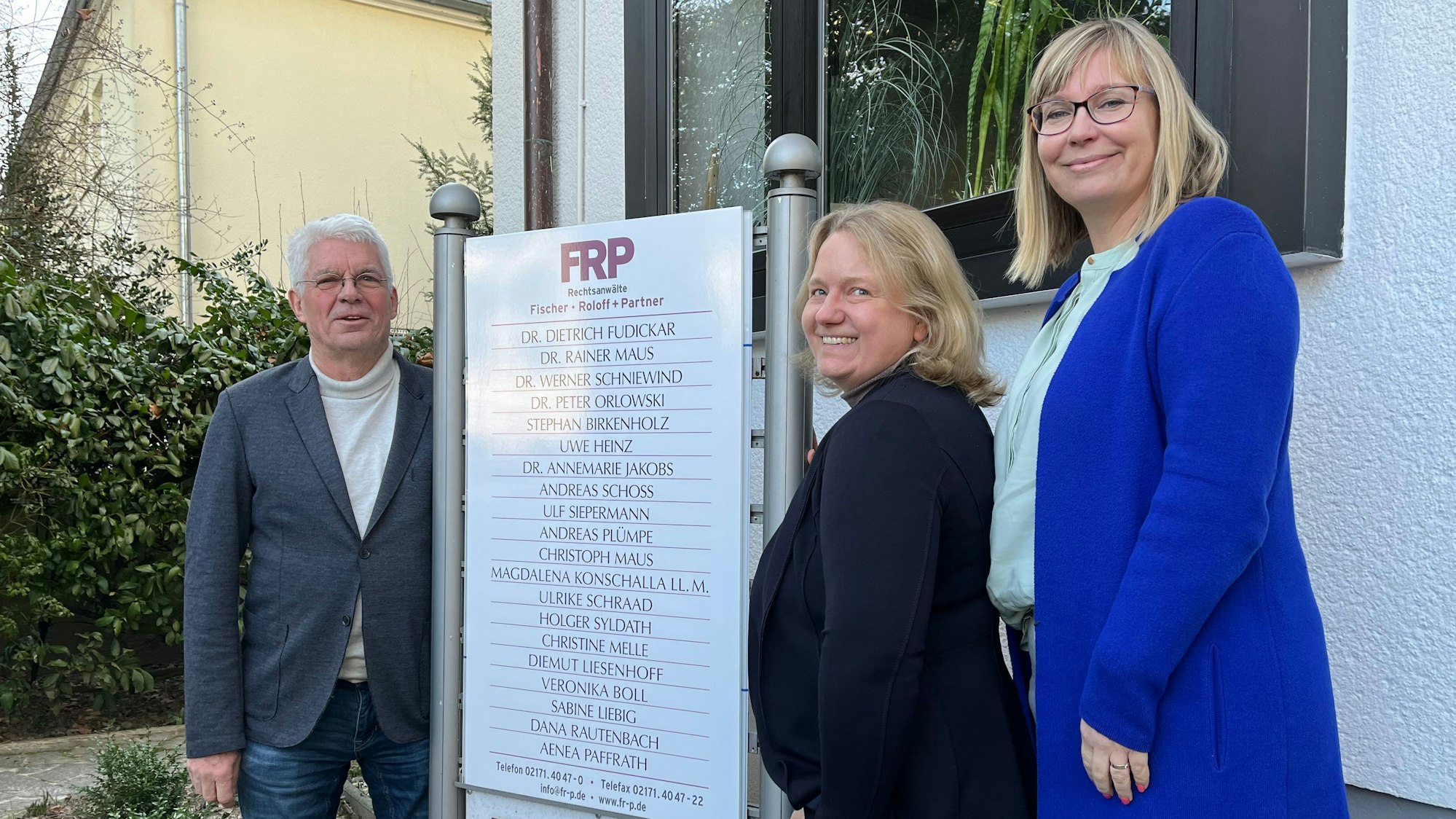 Peter Orlowski, Christine Melle und Magdalena Konschalla stehen vor dem neuen Schild der Kanzlei in der Karl-Bückart-Straße.