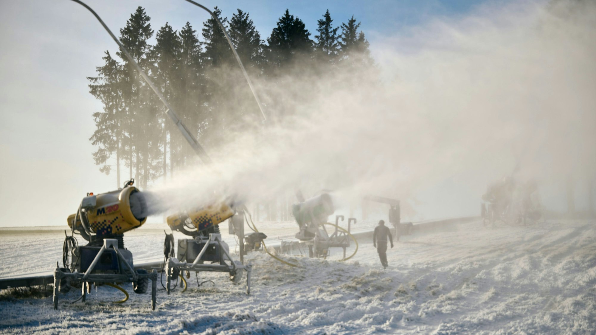 Schneekanonen sind bei strahlendem Sonnenschein in Betrieb. Der Deutsche Wetterdienst (DWD) erwartet in den NRW-Hochlagen örtlich Glättegefahr durch überfrierende Nässe, in Hochlagen des Sauerlandes könne gefrierender Sprühregen nicht ausgeschlossen werden. Schnee oder Schneeregen wird zum Wochenende hin erwartet.