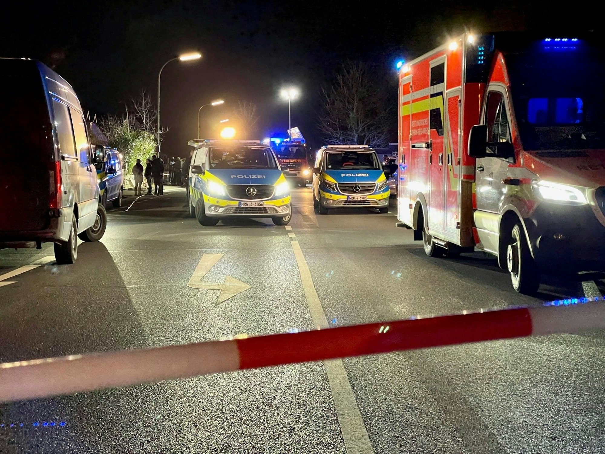 Police and ambulance at a night scene.
