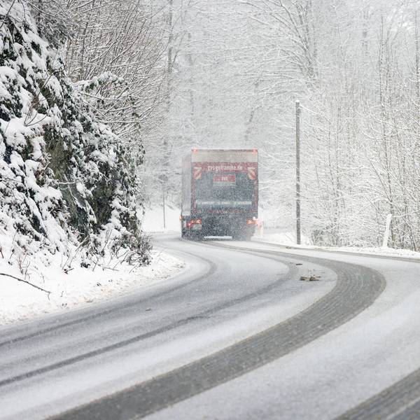 Winter im Siegerland. Winterliche Straßenverhältnisse. Ein Lastwagen fährt über die verschneite L907 bei Siegen-Gosenbach.