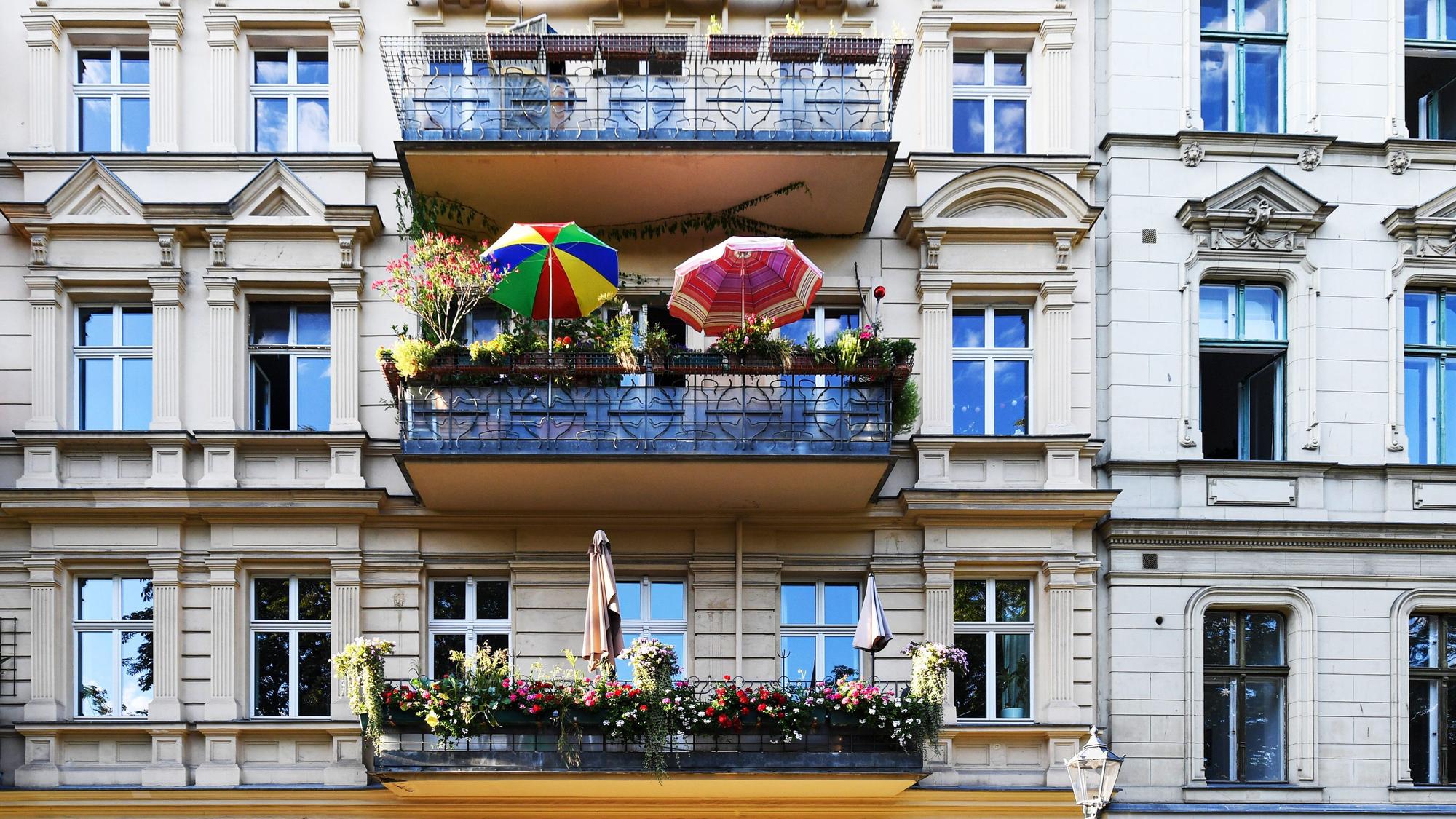 Eine Hausfassade mit schön bepflanzten Balkonen.