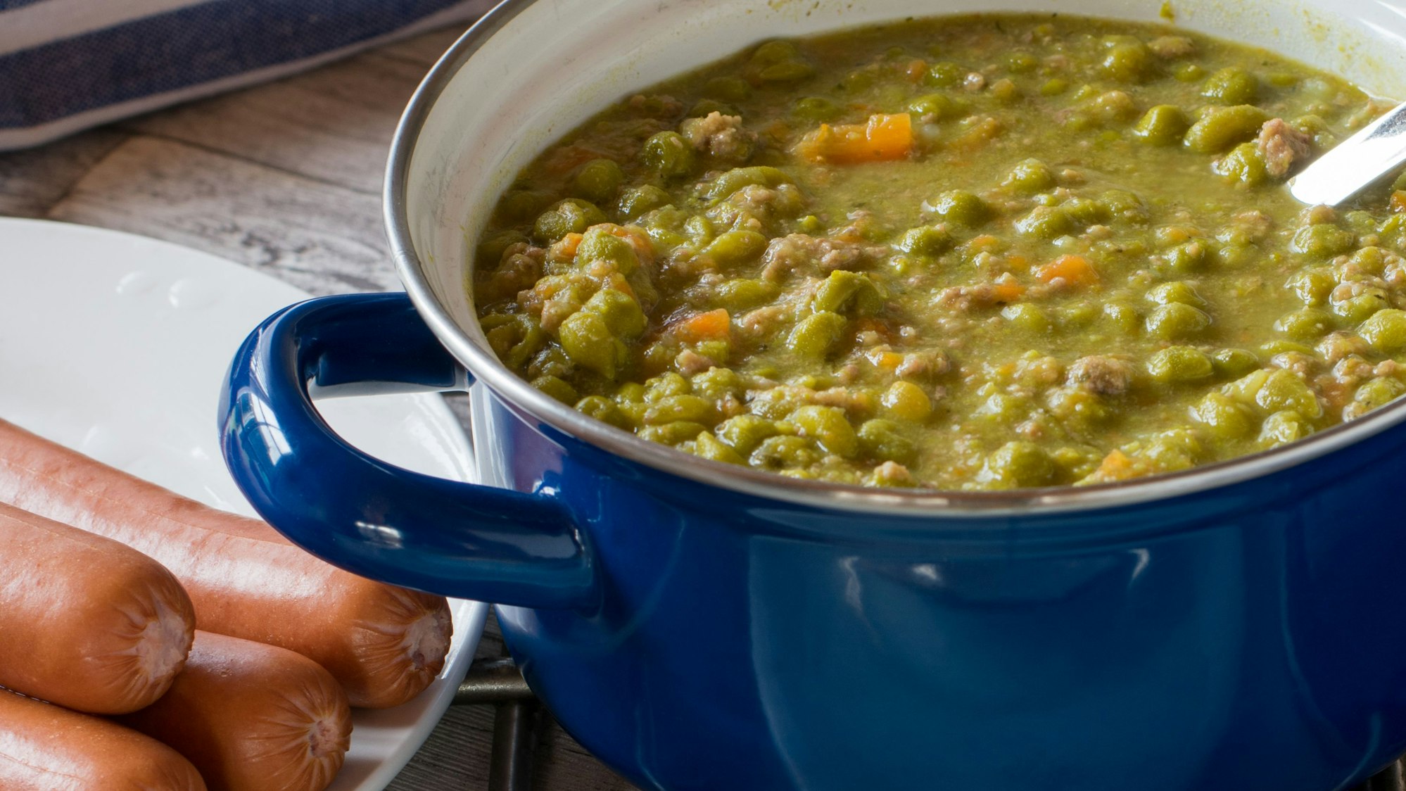 Nahaufnahme einer Erbsensuppe in einem blauen Emaille-Topf