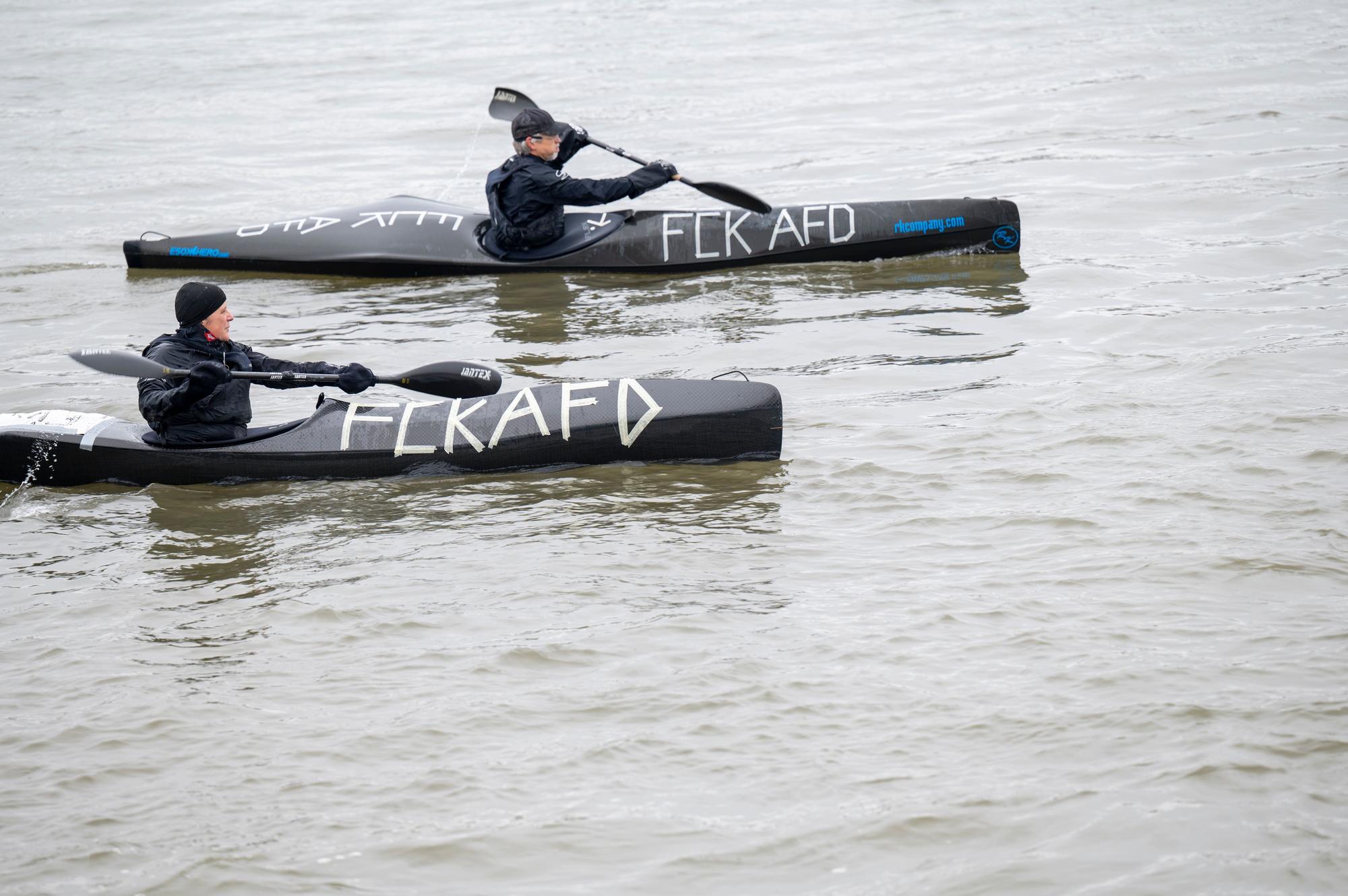 Schwarze Kanus mit der Aufschrift „FCKAFD“ auf dem Rhein.
