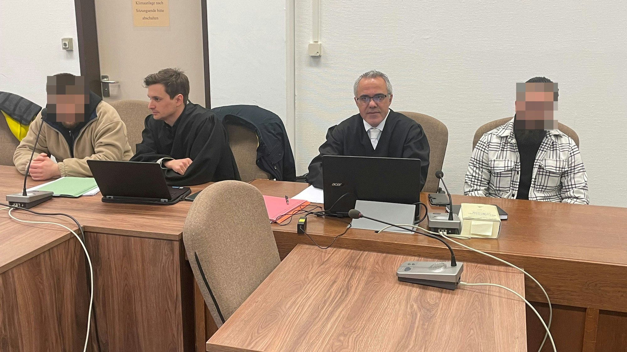 Die Angeklagten mit ihren Verteidigern Alexander Gorski und Bülent Karakus beim Prozessauftakt im Landgericht Köln.