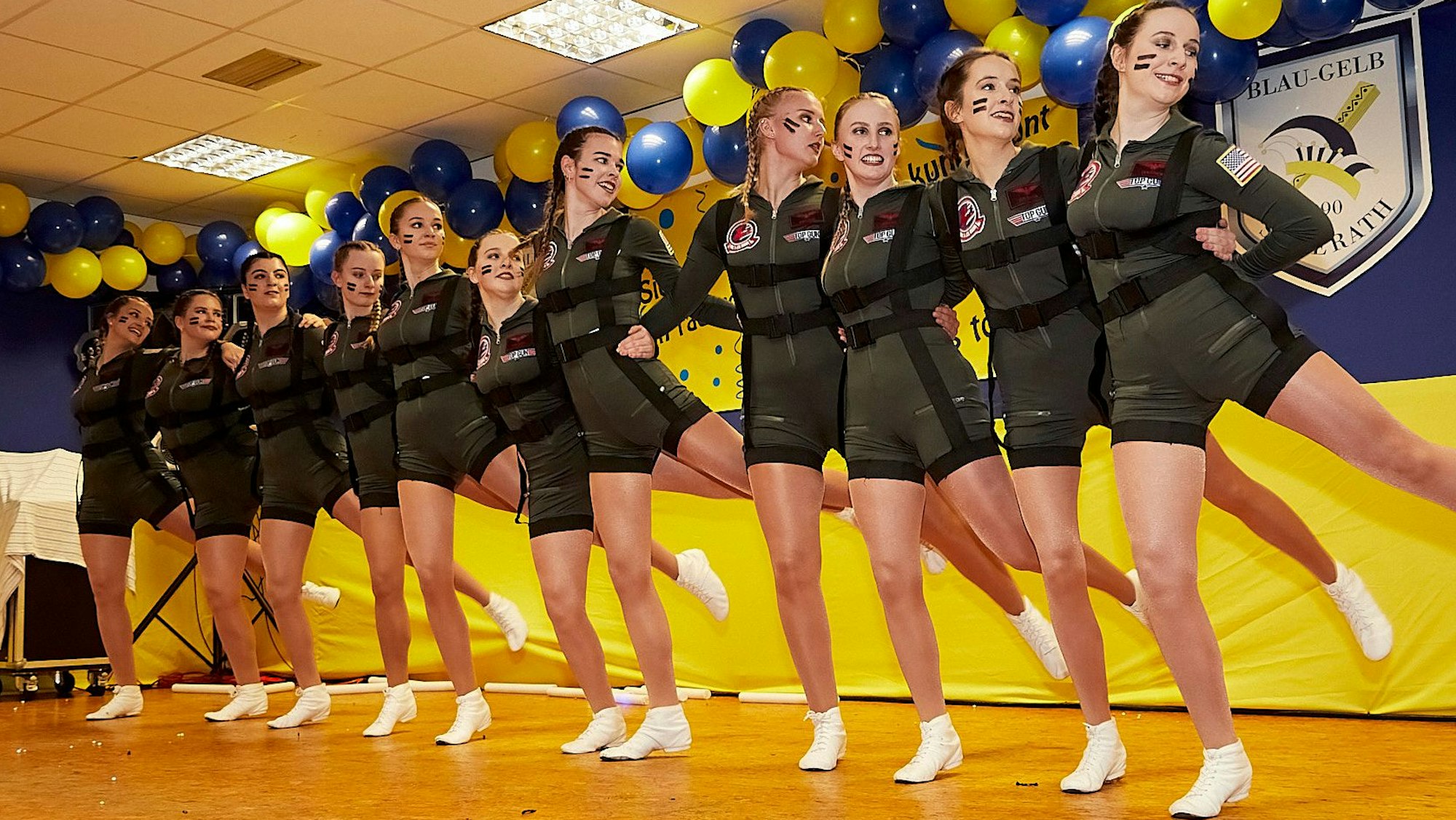Die Frauen der Garde beim Tanz auf der in blau-gelb geschmückten Bühne.