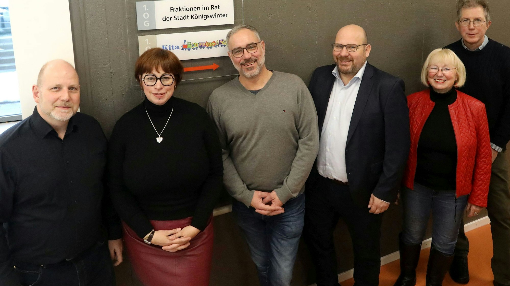 Eine Gruppe von Männern und Frauen stellen sich zum Gruppenfoto.