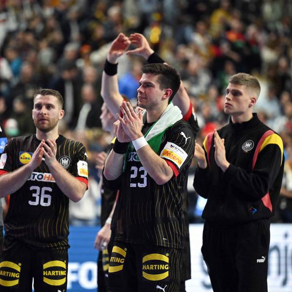 Germany's right back #23 Renars Uscins (2R) and team mates celebrate at the end of the Men's EURO 2024 EHF Handball European Championship main round match between Germany and Croatia in Cologne, western Germany on January 24, 2024. Croatia won the match 30-24. (Photo by INA FASSBENDER / AFP)