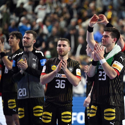 Germany's right back #23 Renars Uscins (2R) and team mates celebrate at the end of the Men's EURO 2024 EHF Handball European Championship main round match between Germany and Croatia in Cologne, western Germany on January 24, 2024. Croatia won the match 30-24. (Photo by INA FASSBENDER / AFP)