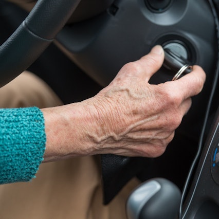 Das Symbolbild zeigt die Hand einer älteren Frau, die mit dem Zündschlüssel ihr Auto startet.