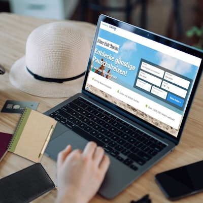 Cropped hand of woman shopping online for flight tickets on airline website with laptop. Carried out Coronavirus rapid self test, negative rapid lateral flow test device and travel essentials on table. Planning for travel. Travel during pandemic concept