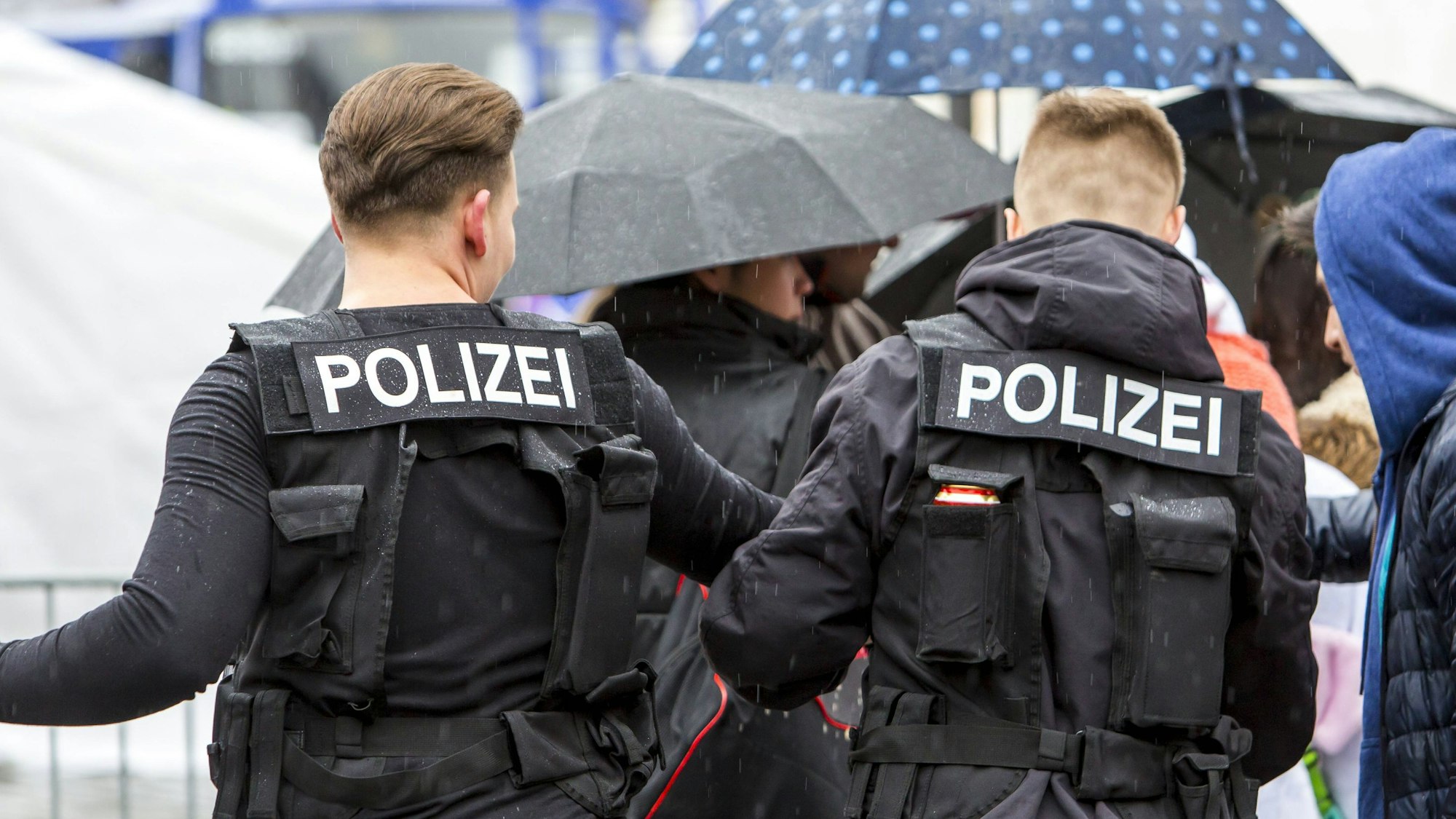 Zwei junge Männer tragen Polizei-Kostüme.