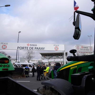 Tractors park outside the Rungis international market, which supplies the capital and surrounding region with much of its fresh food, Wednesday, Jan. 31, 2024 in Rungis, south of Paris. French farmers maintained their protests on major roads around Paris and across the country on Wednesday as police was deployed to protect the capital, its airports and an international market. (AP Photo/Christophe Ena)