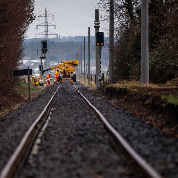 Arbeiter der Bahn bei der Sanierung der Bahnstrecke zwischen Euskirchen und Bad Münstereifel. Im Hintergrund ist der Mast einer Hochspannungsleitung zu sehen.