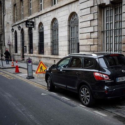 Cars are parked in Paris city center on February 2, 2024 as Paris' city hall is organizing a vote on February 4 on the creation of a special parking fee for heaviest and most polluting cars and SUVs. (Photo by Dimitar DILKOFF / AFP)