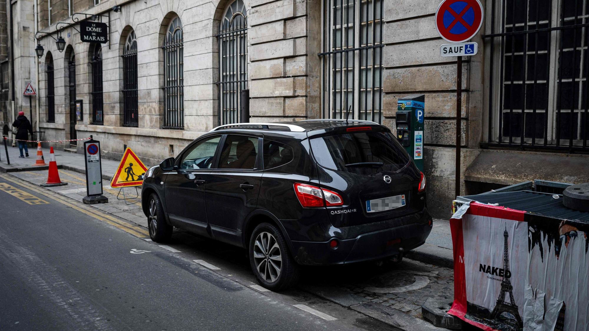 Cars are parked in Paris city center on February 2, 2024 as Paris' city hall is organizing a vote on February 4 on the creation of a special parking fee for heaviest and most polluting cars and SUVs. (Photo by Dimitar DILKOFF / AFP)