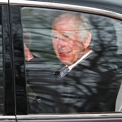 Britain's King Charles III and Britain's Queen Camilla wave as they leave by car from Clarence House in London on February 6, 2024. King Charles III's estranged son Prince Harry reportedly arrived in London on Tuesday after his father's diagnosis of cancer, which doctors "caught early". (Photo by HENRY NICHOLLS / AFP)