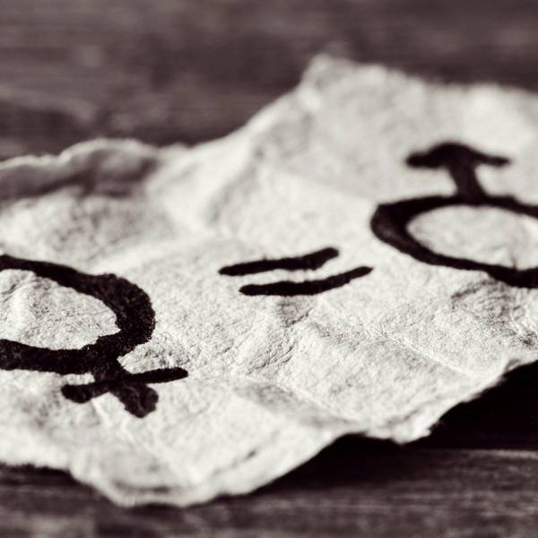 Frauensymbol und Männersymbol auf einem Zettel, dazwischen ein Gleichzeichen