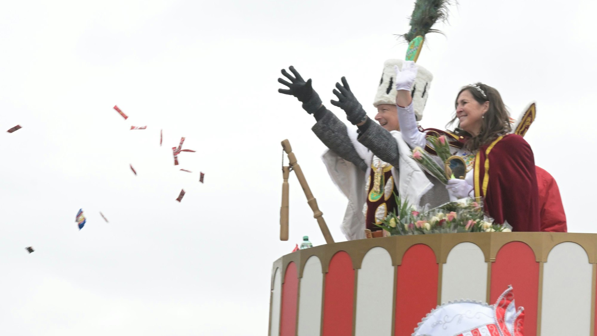 Jungfrau Sabine und Bauer Gerd stehen auf dem Wagen und Werfen Kammelle.