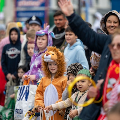 Kinder warten am Rande des Veedelszochs in Höhenberg auf Kamelle.