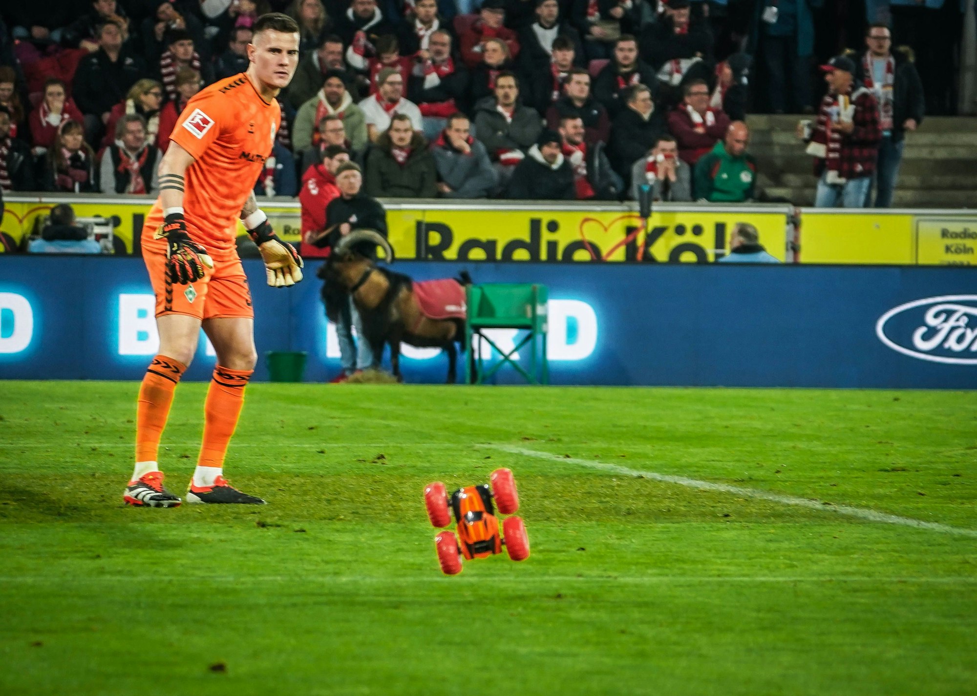Ferngesteuertes Auto springt im Strafraum durch die Luft, Werder.Keeper Zetterer schaut hin