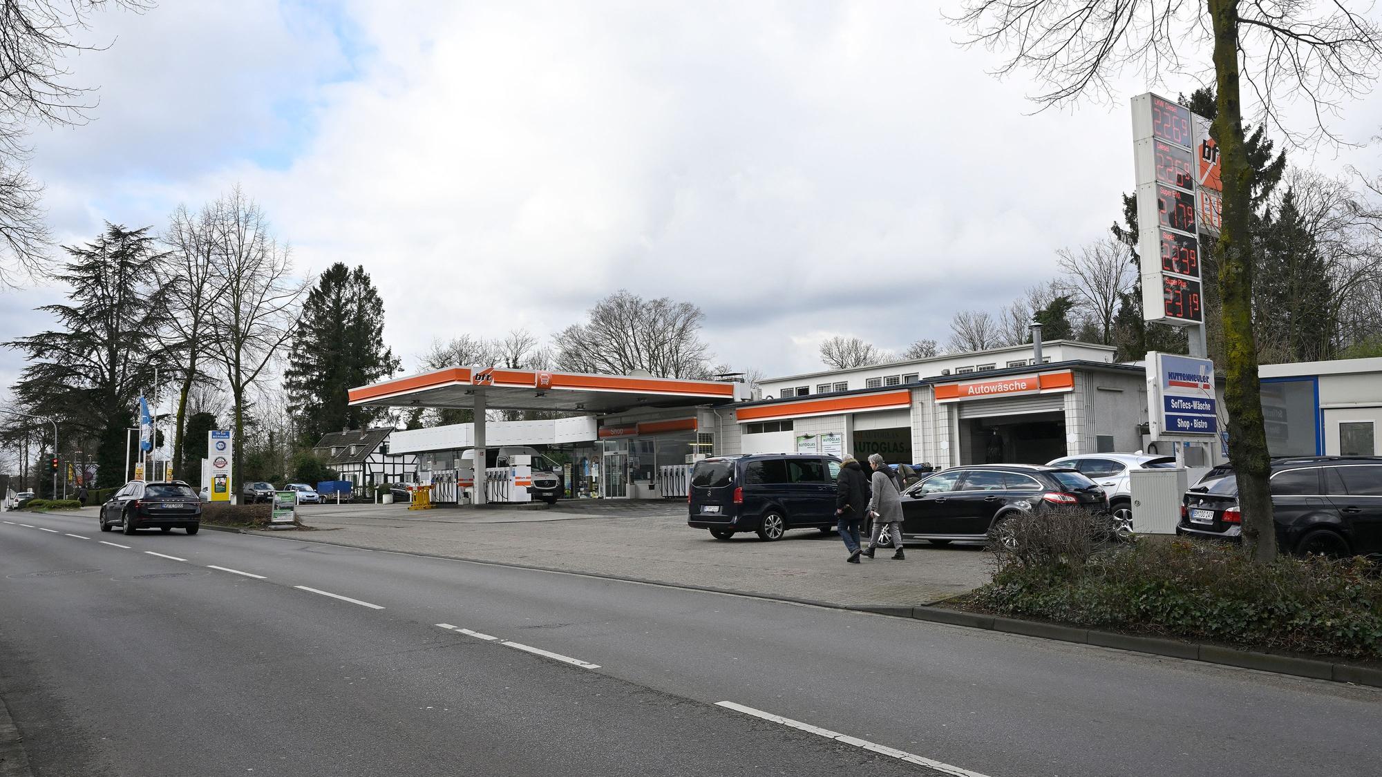 Zu sehen ist im Vordergrund die Fahrbahn, am Straßenrand befindet sich eine Tankstelle.
