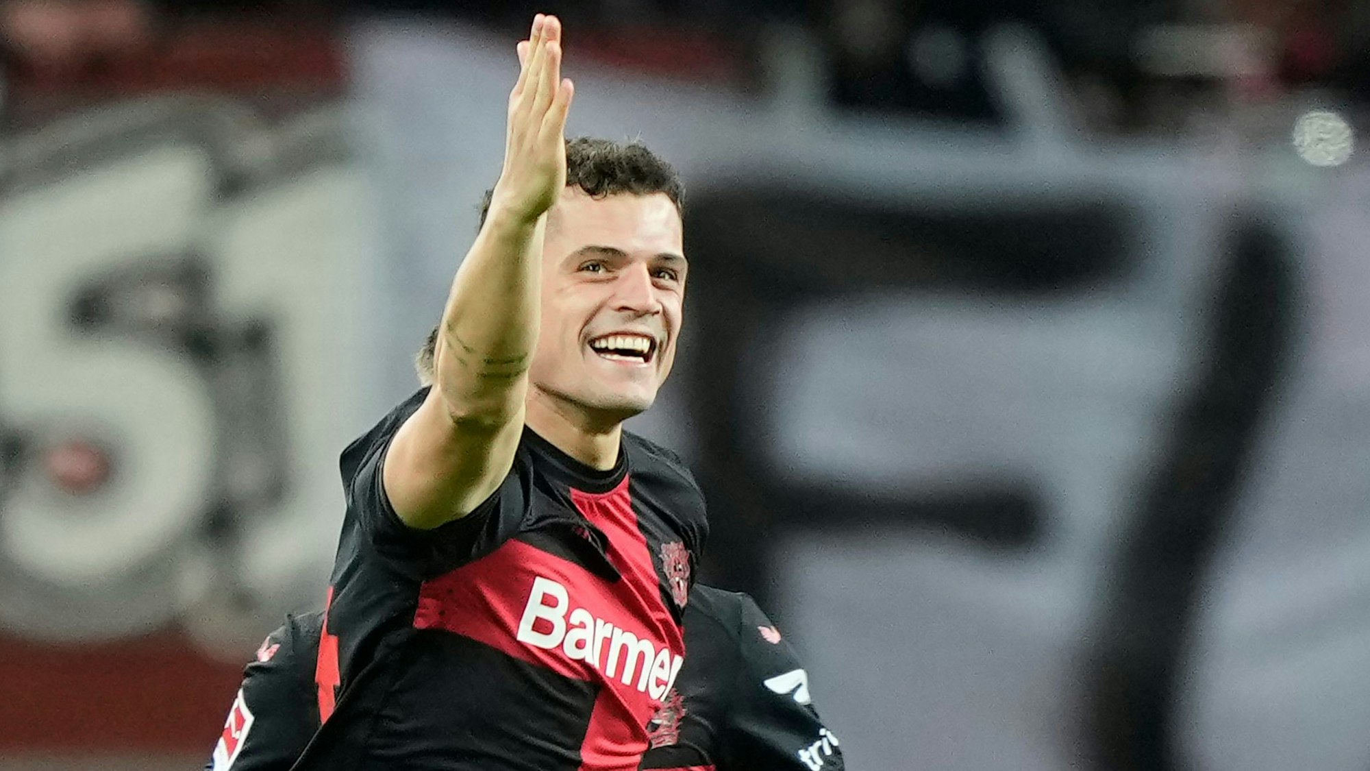 Leverkusen's Granit Xhaka celebrates after scoring the opening goal the German Bundesliga soccer match between Bayer 04 Leverkusen and 1. FSV Mainz 05 at the BayArena in Leverkusen, Germany, Friday, Feb. 23, 2024. (AP Photo/Martin Meissner)