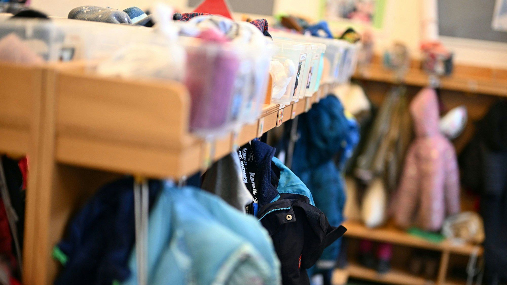 Das Bild zeigt die Garderobe in einer Kita mit Jacken und weiterer Kleidung.