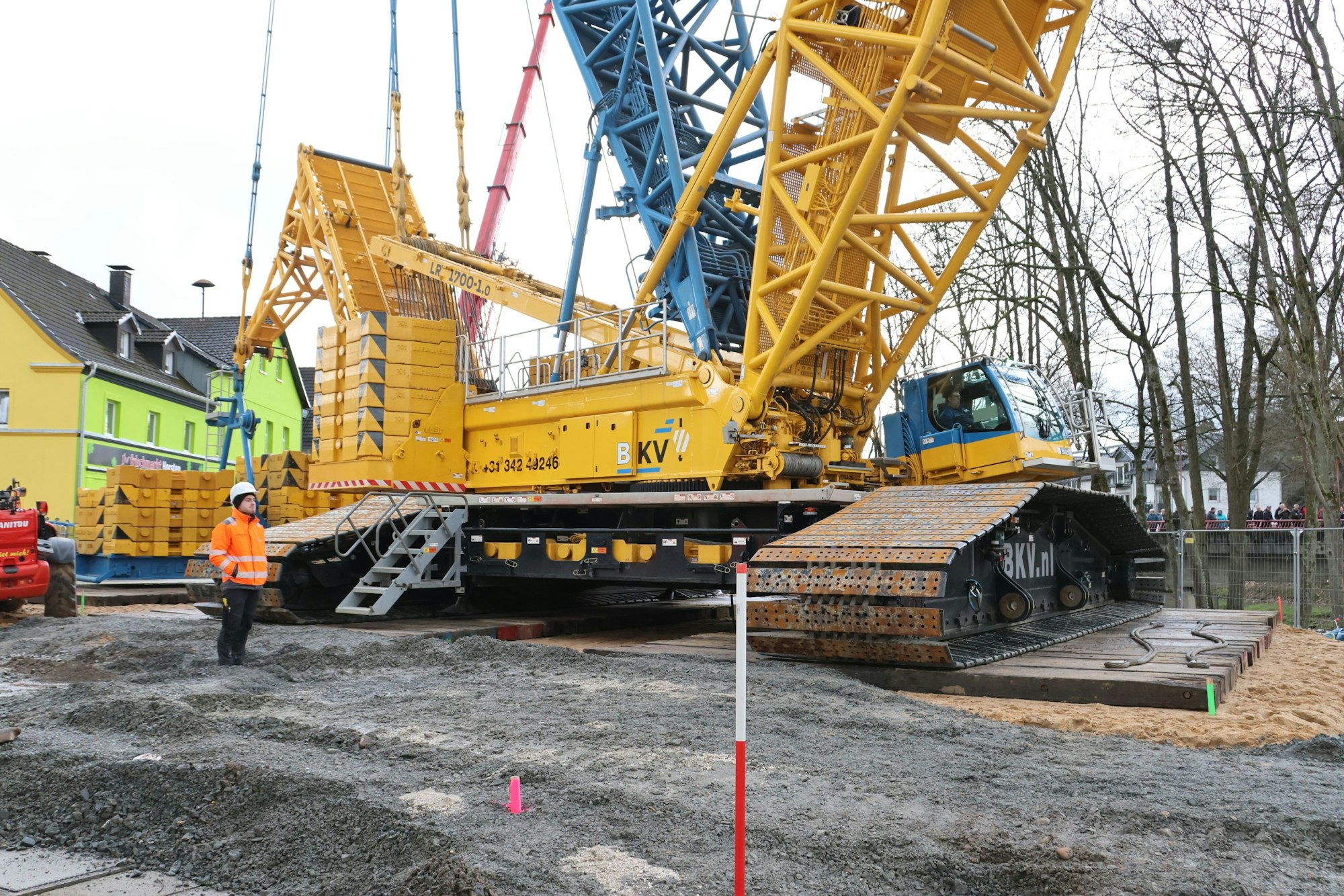 Ein hausgroßer Kran steht auf einer Baustelle.