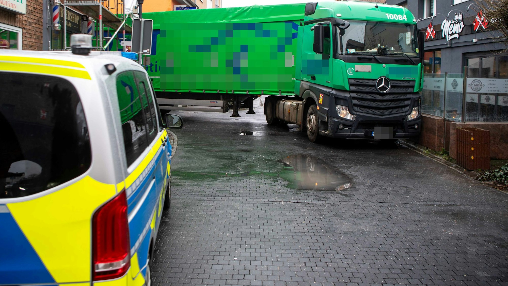 Das Foto zeigt den zwischen den Gebäuden verkeilten Lastzug.