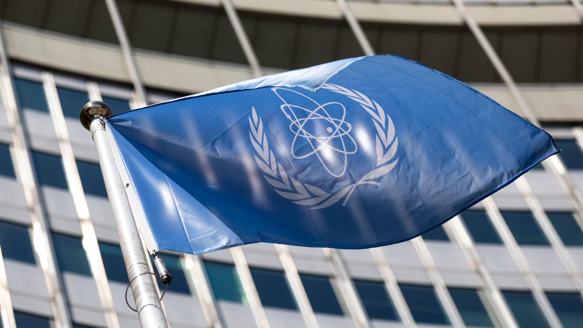 ARCHIV - 07.06.2021, Österreich, Wien: Die Flagge der Internationalen Atomenergie-Organisation, IAEA, weht am Eingang des Vienna International Center.