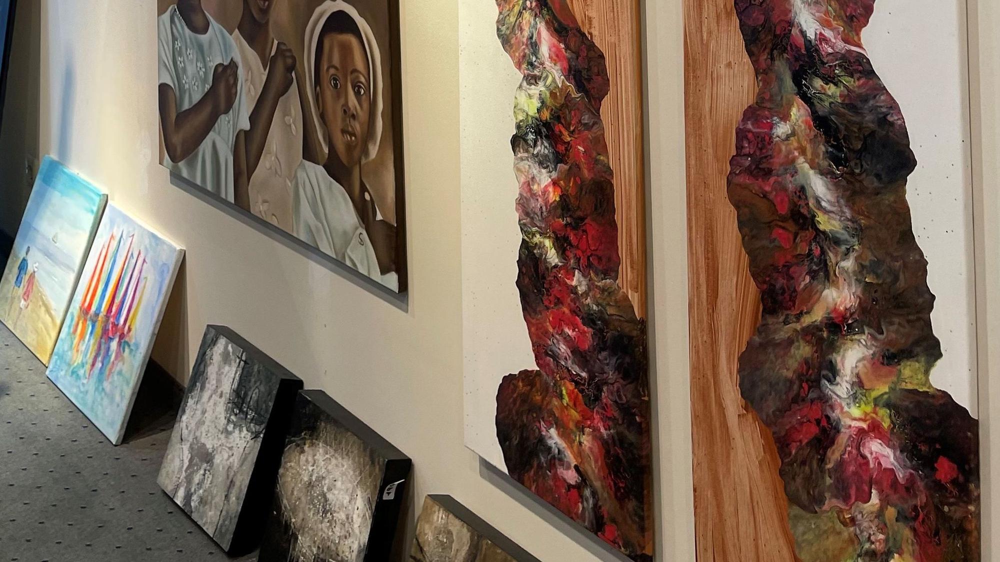 Bilder hängen und stehen an der Wand.