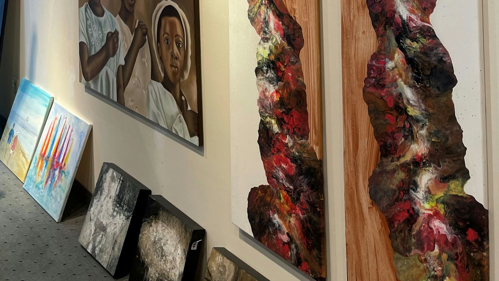 Bilder hängen und stehen an der Wand.