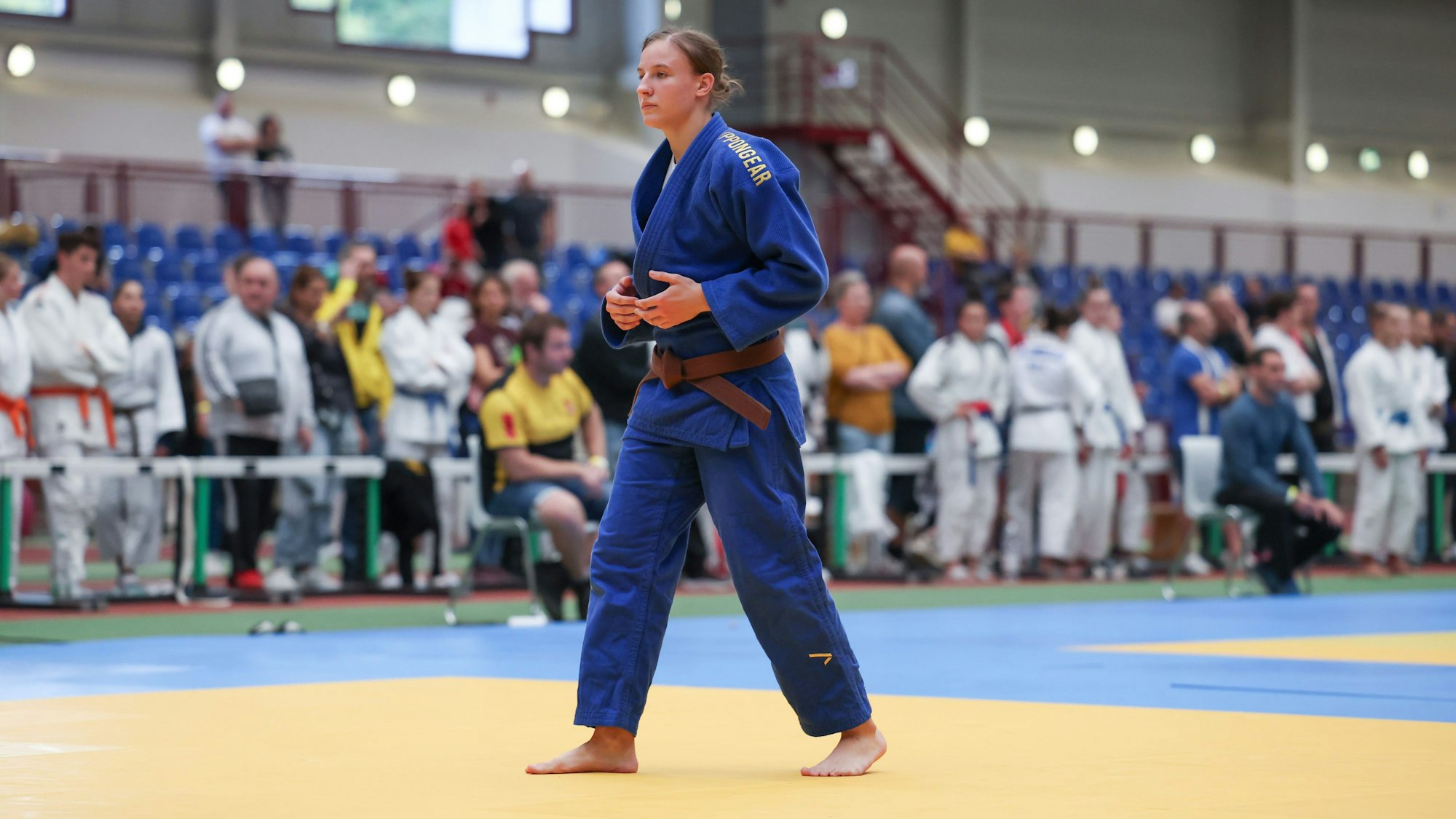 Sveyarike Konrad beim Turnier in Leverkusen. Sie trägt einen blauen Judoanzug und einen braunen Gürtel.