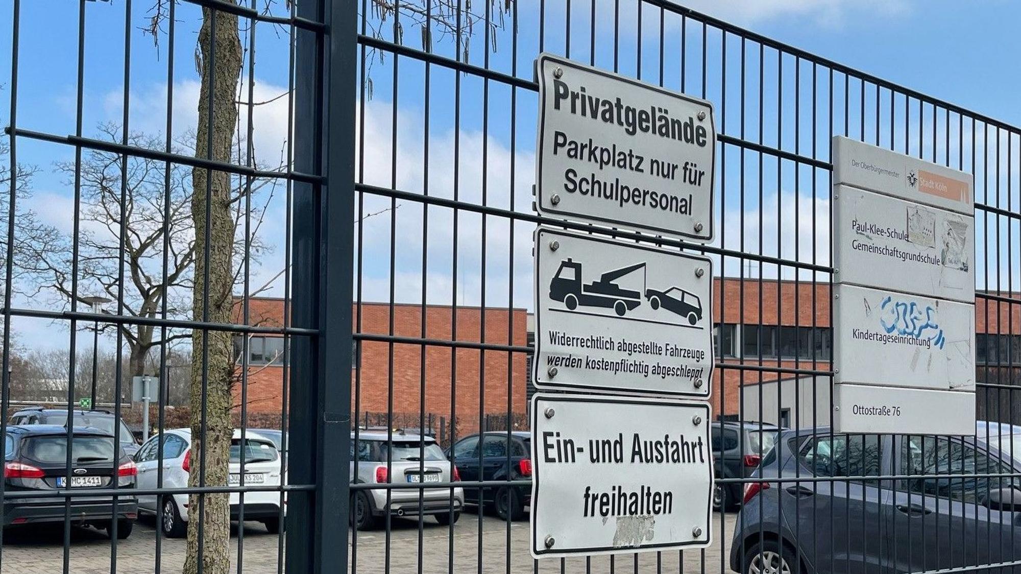 Ein Parkplatz vor einer Schule.