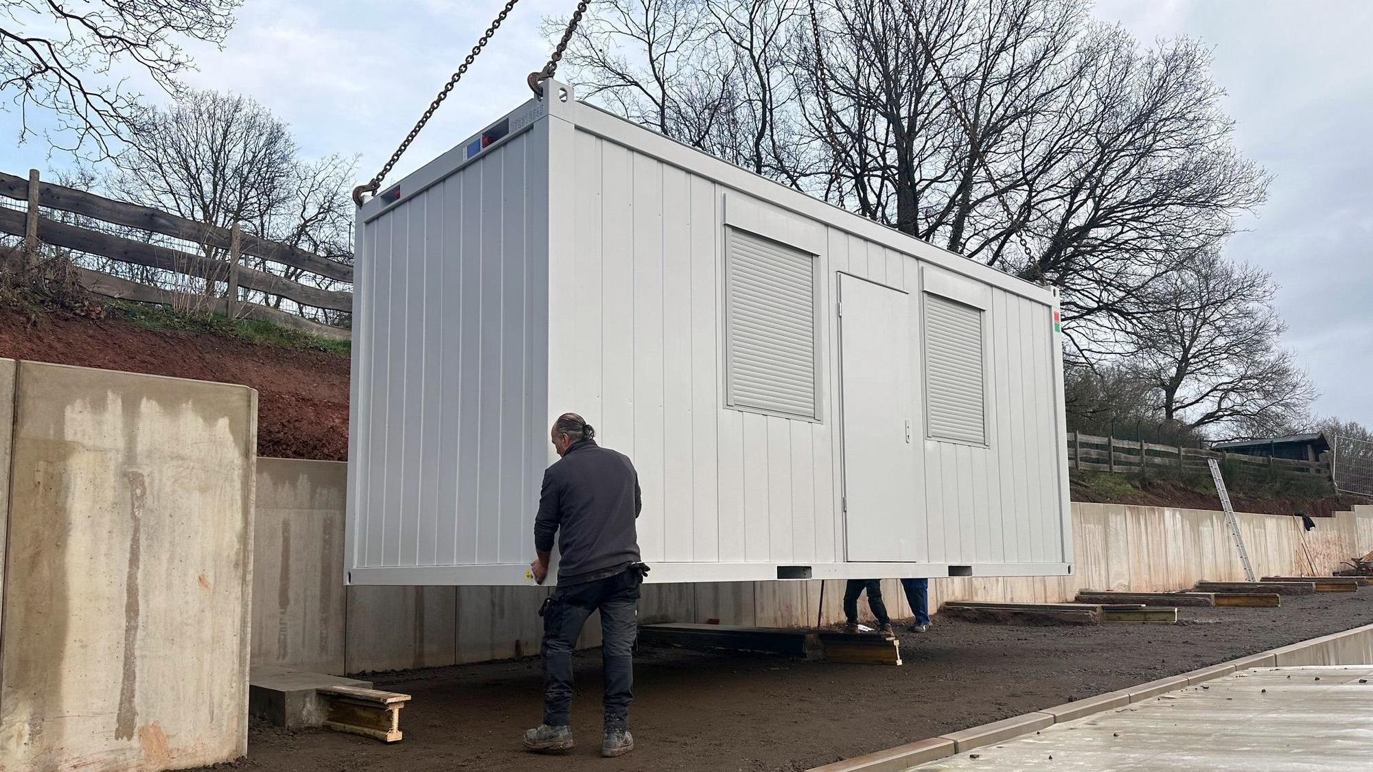 Auf dem Gelände des Mechernicher Tierheims wird ein Container an seinem Standplatz abgestellt.
