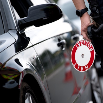 Polizisten kontrollieren ein Auto.