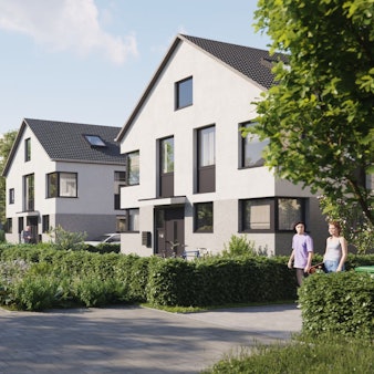 Eine verkehrsberuhigte Straße in einem Wohnviertel mit freistehenden Häusern ist zu sehen.