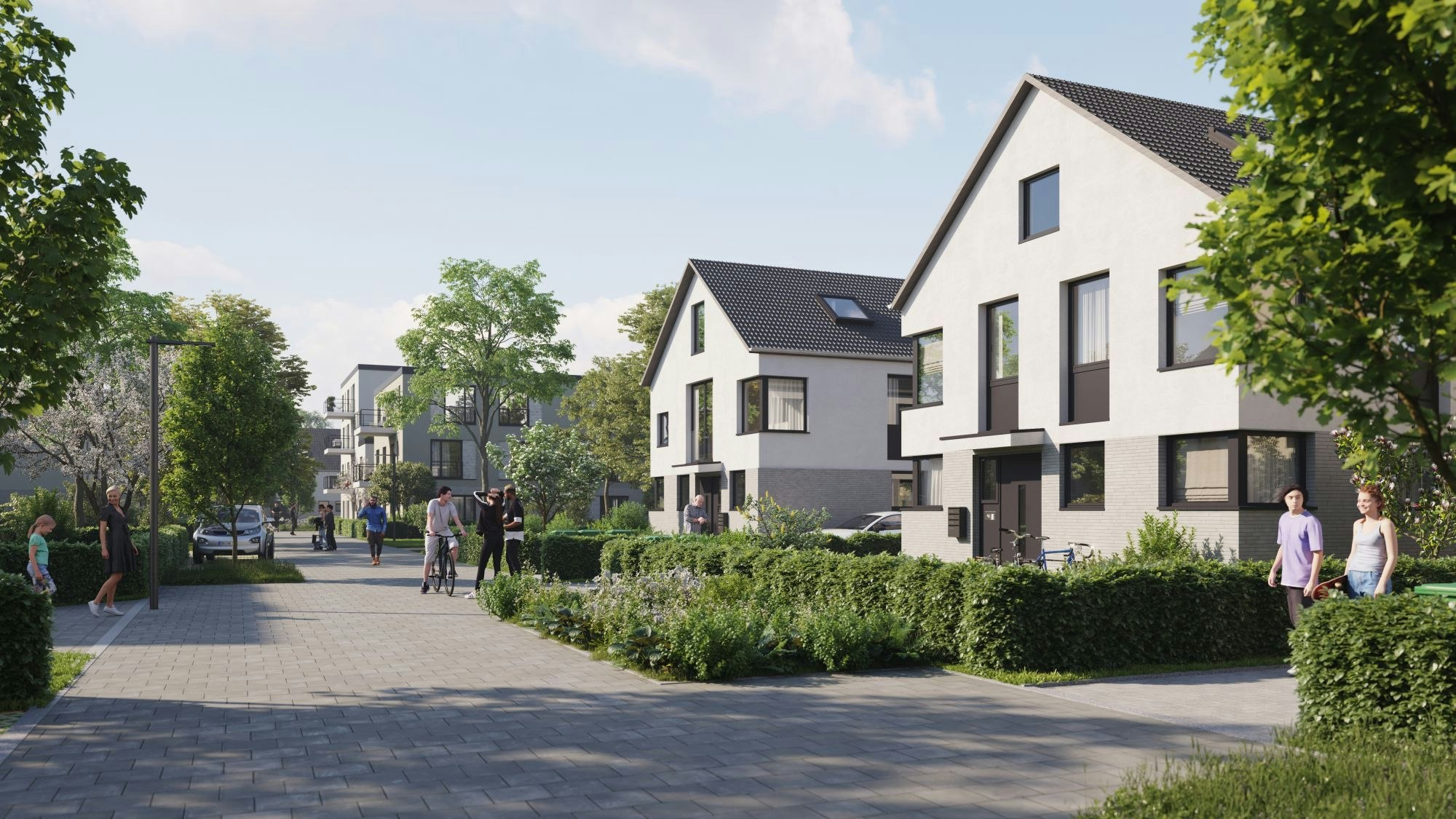 Eine verkehrsberuhigte Straße in einem Wohnviertel mit freistehenden Häusern ist zu sehen.