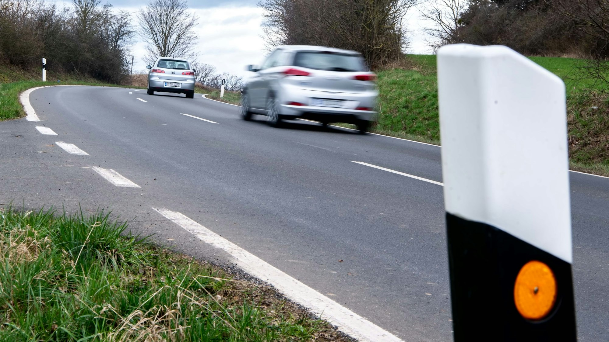 Zwei Autos fahren auf der Straße zwischen Iversheim und Wachendorf.