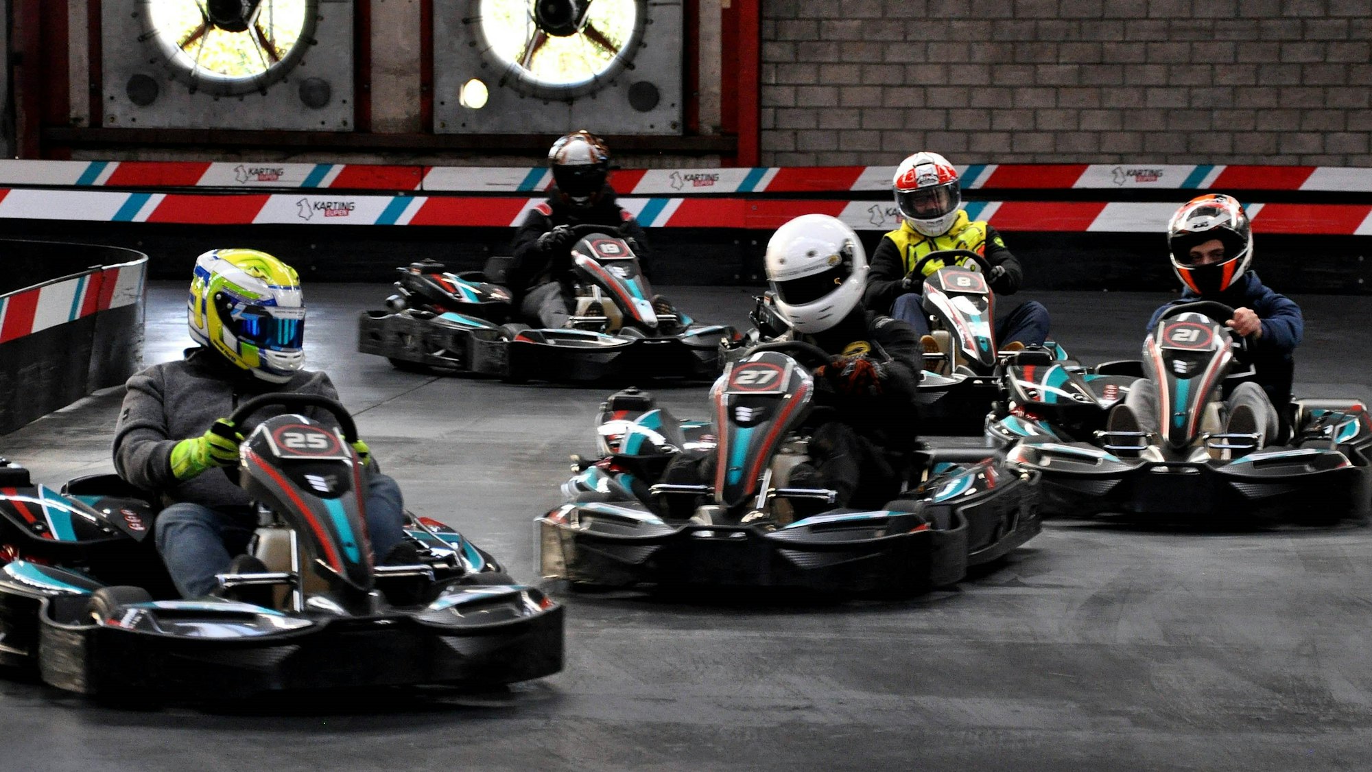 Fünf Rennfahrer fahren mit ihren Karts auf der Kartbahn im belgischen Eupen.