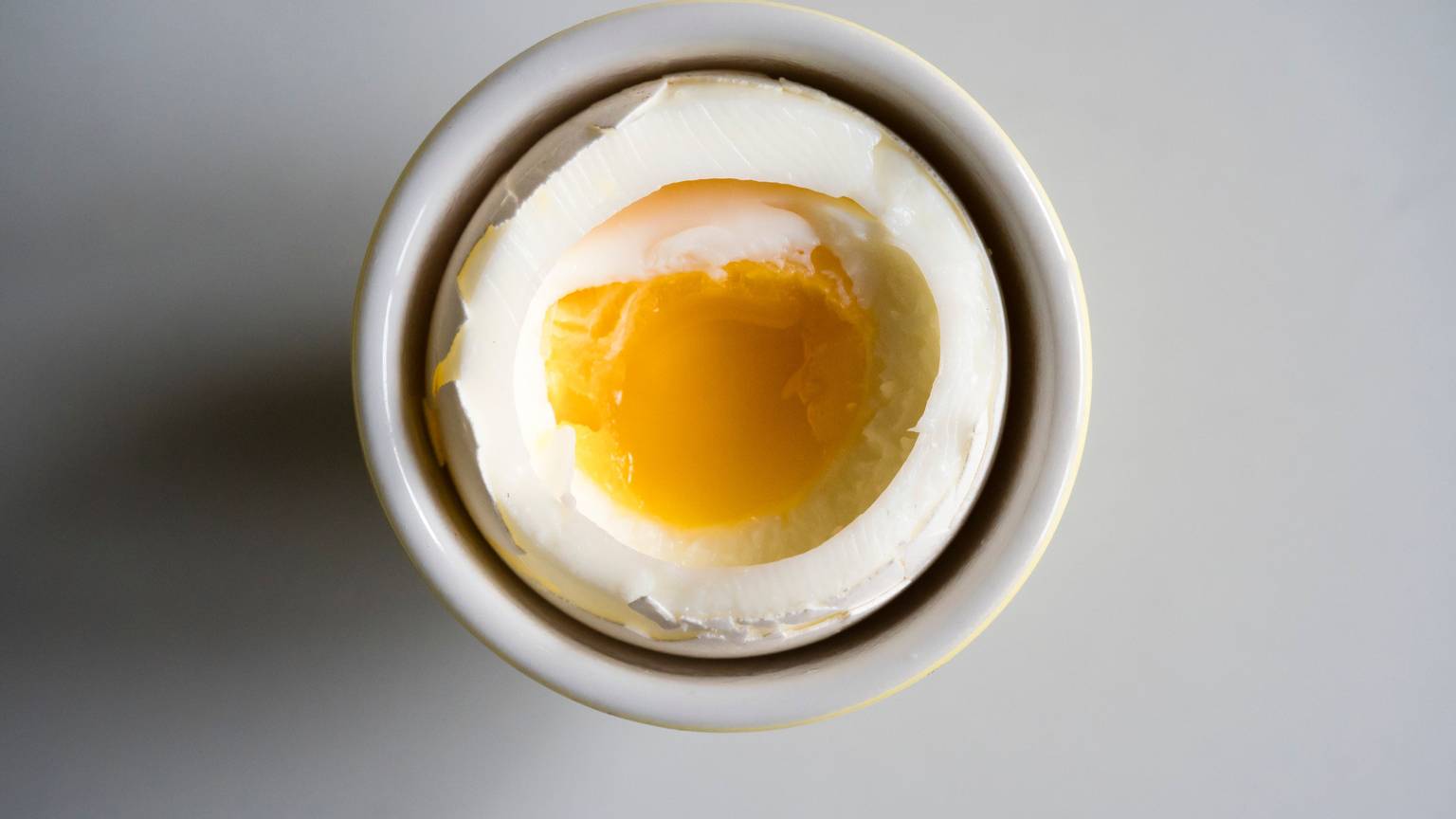Soft boiled breakfast egg on a white porcelain plate
EThamPhoto/ Getty Images