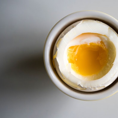 Soft boiled breakfast egg on a white porcelain plate
EThamPhoto/ Getty Images