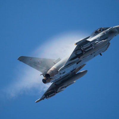 Ein Kampfflugzeug vom Typ Eurofighter Typhoon der Luftwaffe fliegt in dichtem Rauch über einem Stützpunkt der Nato. (Archivbild)