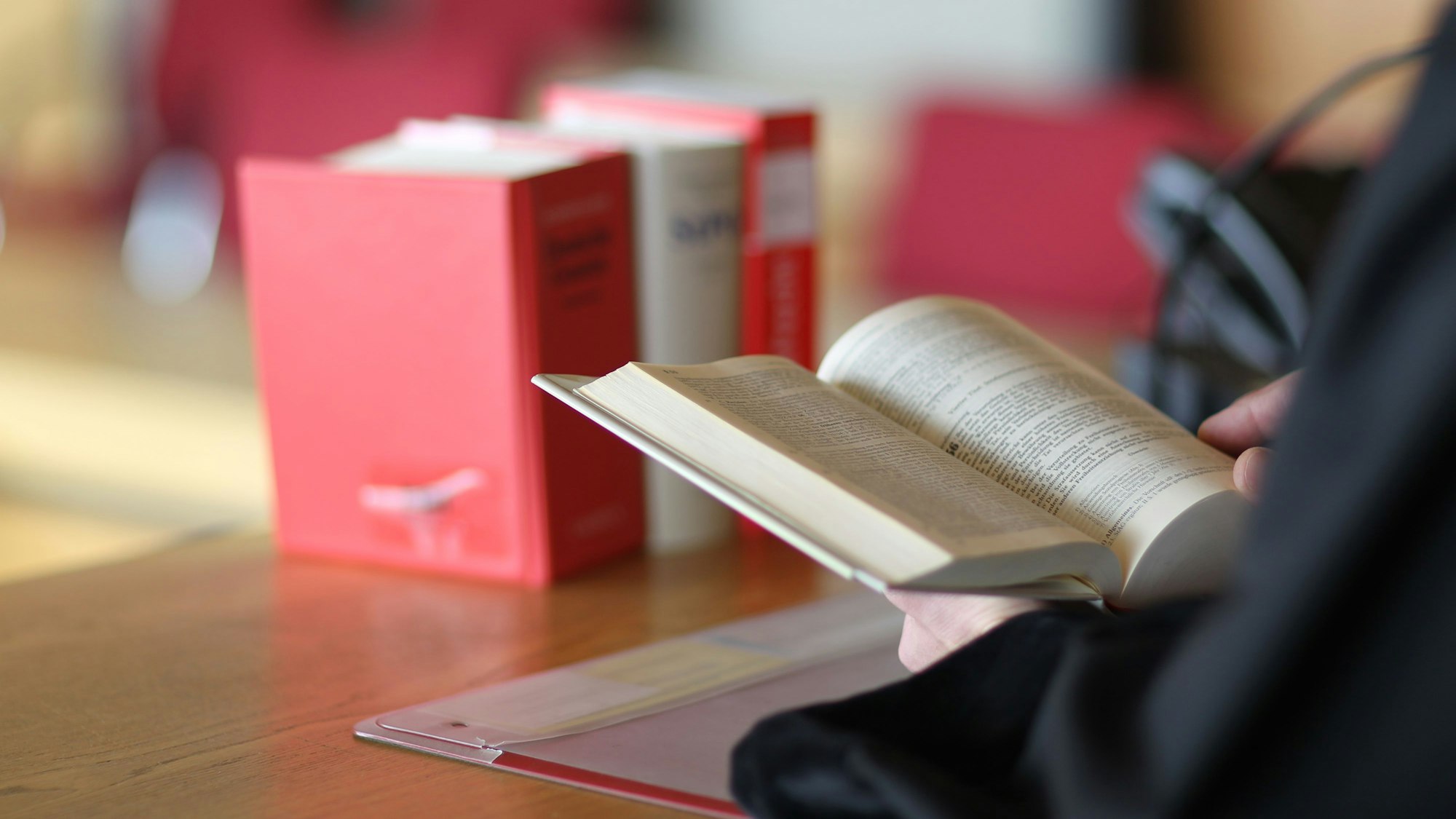 Ein Richter liest in einem Gesetzbuch.