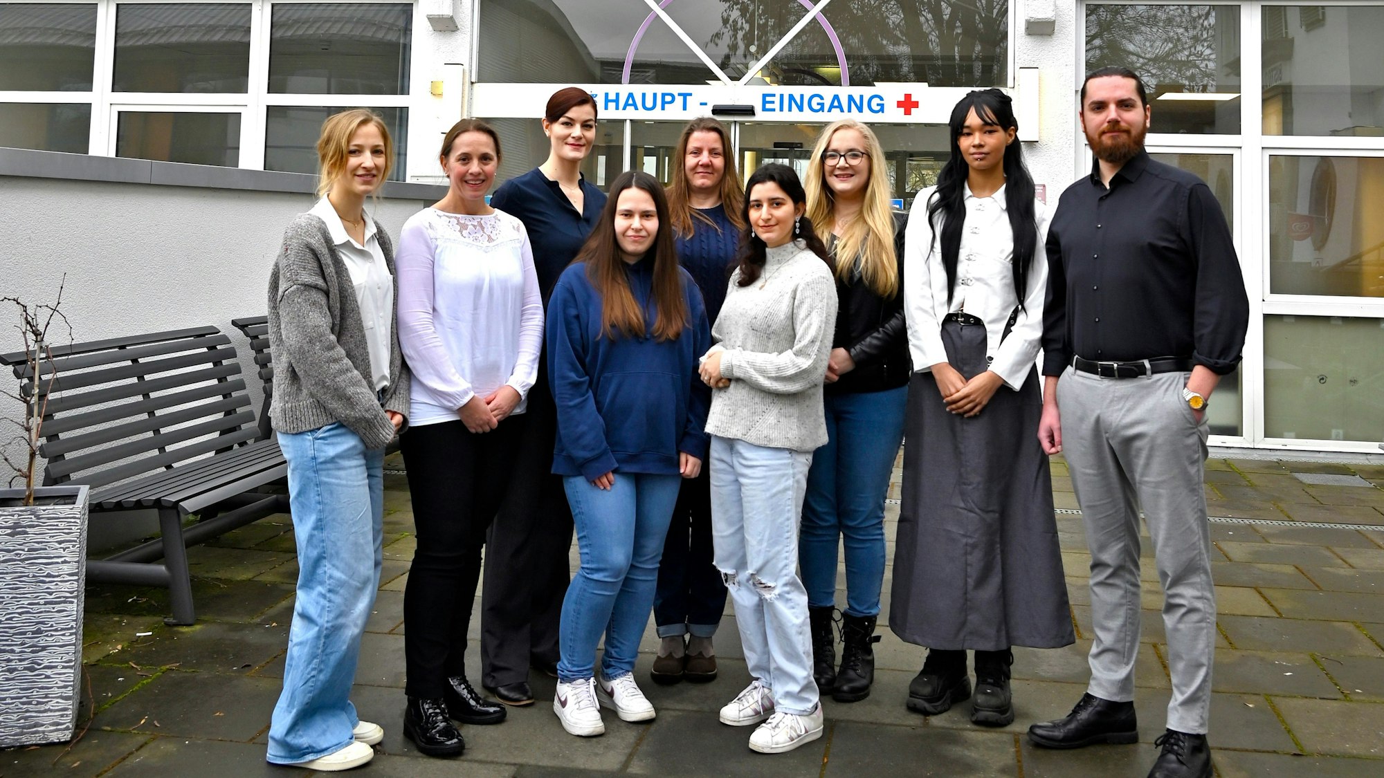 Eine Gruppe von Frauen und Männern vor dem Haupteingang des Sana-Krankenhauses.