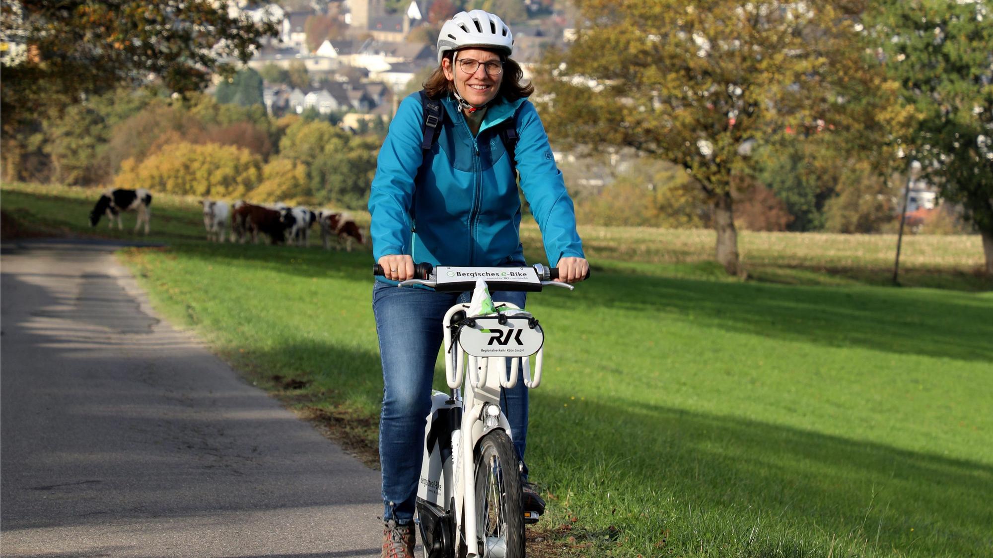 Eine Frau fährt bei Overath einen Berg hinauf.